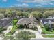 Aerial view of landscaped home showcasing circular driveway and mature trees at 1554 Eagle Nest Cir, Winter Springs, FL 32708