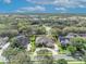 Aerial view of a large home with a circular driveway and a manicured lawn at 1554 Eagle Nest Cir, Winter Springs, FL 32708