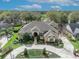 Aerial view of a luxurious home with manicured lawns and garden beds at 1554 Eagle Nest Cir, Winter Springs, FL 32708