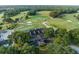 Aerial view of the golf course and clubhouse featuring lush greenery and a scenic landscape at 1554 Eagle Nest Cir, Winter Springs, FL 32708