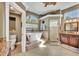 Bright bathroom with a soaking tub and glass block window, plus a walk-in shower and vanity with granite countertops at 1554 Eagle Nest Cir, Winter Springs, FL 32708