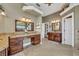 This bathroom offers dual vanities with granite countertops, dark wood cabinets, and ample space at 1554 Eagle Nest Cir, Winter Springs, FL 32708