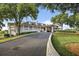 Exterior view of the clubhouse featuring covered verandas, stone accents, and a well-maintained driveway at 1554 Eagle Nest Cir, Winter Springs, FL 32708