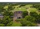 A view of the clubhouse entrance surrounded by green fairways and mature trees at 1554 Eagle Nest Cir, Winter Springs, FL 32708