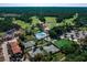 Aerial view of the community featuring a pool, tennis courts, golf course, and lush landscaping at 1554 Eagle Nest Cir, Winter Springs, FL 32708