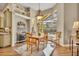 Bright dining room with large windows offering views of the screened-in pool and outdoor area at 1554 Eagle Nest Cir, Winter Springs, FL 32708