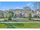 The exterior of this home features mature landscaping, a circular driveway and beautiful architecture at 1554 Eagle Nest Cir, Winter Springs, FL 32708