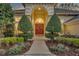 A walkway leads to the home's front door, flanked by well-manicured shrubbery and arched windows at 1554 Eagle Nest Cir, Winter Springs, FL 32708