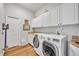 Spacious laundry room featuring granite countertops, custom cabinets, and modern appliances at 1554 Eagle Nest Cir, Winter Springs, FL 32708