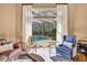 Living room with sliding glass doors opening to a screened patio with swimming pool at 1554 Eagle Nest Cir, Winter Springs, FL 32708