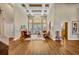 Living room with high ceilings, wood floors, and French doors leading to the pool area at 1554 Eagle Nest Cir, Winter Springs, FL 32708