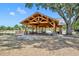 A wooden picnic pavilion with picnic tables set near a lake and mature trees at 1554 Eagle Nest Cir, Winter Springs, FL 32708