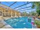 An enclosed pool with an attached spa and a covered patio with furniture at 1554 Eagle Nest Cir, Winter Springs, FL 32708