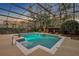 A screened-in pool has blue water and is framed by tropical greenery at 1554 Eagle Nest Cir, Winter Springs, FL 32708