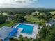 Aerial shot of the pool and surrounding recreational area, including lush greenery and community amenities at 1554 Eagle Nest Cir, Winter Springs, FL 32708