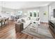 Spacious living room with hardwood floors, contemporary decor, and a seamless connection to the dining area at 16417 Silver Brook Way, Winter Garden, FL 34787