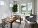 Bright home office with a modern desk, white chair, gray accent chair, and a scenic view of the lake at 16420 Silver Grove Blvd, Winter Garden, FL 34787