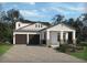 Charming home exterior showcasing a two-car garage, landscaped yard, and inviting front porch at 16450 Silver Grove Blvd, Winter Garden, FL 34787