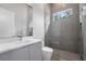 Modern bathroom featuring textured tile, glass shower, floating vanity, and stylish fixtures at 17038 Medici Way, Bella Collina, FL 34756