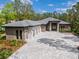 Beautiful exterior view with a three-car garage and a paved driveway leading to the front entrance at 17038 Medici Way, Bella Collina, FL 34756