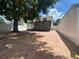 View of home's paved backyard with a large tree and a screened-in lanai at 1714 Sherbourne St, Winter Garden, FL 34787