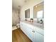 Modern bathroom featuring double sinks, granite countertops, sleek mirrors, and a beautifully tiled shower at 1714 Sherbourne St, Winter Garden, FL 34787