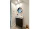 Stylish bathroom boasts a modern vanity, round mirror, and contemporary fixtures at 1714 Sherbourne St, Winter Garden, FL 34787