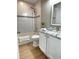 Cozy bathroom featuring tiled walls, a bathtub with shower, granite countertops, and wood look flooring at 1714 Sherbourne St, Winter Garden, FL 34787