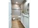 Cozy bathroom featuring tiled walls, a bathtub with shower, granite countertops, and wood look flooring at 1714 Sherbourne St, Winter Garden, FL 34787