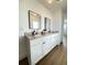 Bathroom showcasing a double vanity with white cabinetry and granite countertops at 1714 Sherbourne St, Winter Garden, FL 34787