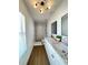 Modern bathroom featuring a double vanity with stone countertops and a tiled shower at 1714 Sherbourne St, Winter Garden, FL 34787