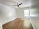 Spacious bedroom featuring wood look flooring, a ceiling fan, a window, and white walls at 1714 Sherbourne St, Winter Garden, FL 34787