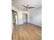 Bright bedroom featuring wood look flooring, a ceiling fan, and a large closet at 1714 Sherbourne St, Winter Garden, FL 34787