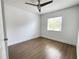 Bright bedroom featuring wood look flooring, a ceiling fan, a window, and white walls at 1714 Sherbourne St, Winter Garden, FL 34787