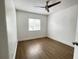 Bedroom featuring wood look flooring, a ceiling fan, a window, and neutral walls at 1714 Sherbourne St, Winter Garden, FL 34787