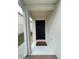 A clean and simple entrance with a dark-colored front door and neutral exterior at 1714 Sherbourne St, Winter Garden, FL 34787