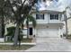 Two-story home with a two car garage, nice landscaping, and black window shutters at 1714 Sherbourne St, Winter Garden, FL 34787