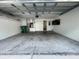 Spacious two car garage with concrete floor and attached storage cabinets at 1714 Sherbourne St, Winter Garden, FL 34787