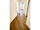 Hallway with wood-look flooring and white trim, leading to bedrooms with ceiling fans at 1714 Sherbourne St, Winter Garden, FL 34787