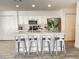 Modern kitchen featuring granite countertops, stainless steel appliances, white cabinetry, and island with bar stool seating at 1714 Sherbourne St, Winter Garden, FL 34787