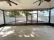 Screened lanai with tile flooring overlooking a paved patio and fenced yard at 1714 Sherbourne St, Winter Garden, FL 34787