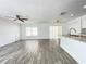 Open-concept living room with wood-look tile flooring and plenty of natural light at 1714 Sherbourne St, Winter Garden, FL 34787