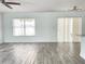 Bright living room with wood-look tile flooring, natural light, and neutral paint at 1714 Sherbourne St, Winter Garden, FL 34787