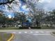 Community playground with a colorful play structure and mature shade trees at 1714 Sherbourne St, Winter Garden, FL 34787