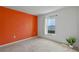 Bedroom featuring an orange wall and a window allowing for lots of natural light at 1744 Wilson Prairie Cir, Groveland, FL 34736