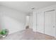 Bedroom featuring a closet with sliding doors, a plant, and neutral walls with carpeted floor at 1744 Wilson Prairie Cir, Groveland, FL 34736