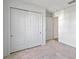 Bedroom with carpeted floors, double door closet, and doorways leading to other rooms in the home at 1744 Wilson Prairie Cir, Groveland, FL 34736