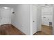 Hallway featuring a door to a laundry room with wire shelving at 1744 Wilson Prairie Cir, Groveland, FL 34736