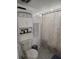 Bathroom featuring a toilet, decorative shelf, and shower with curtain at 1912 Cattleya Dr # 1912, Kissimmee, FL 34741