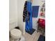 Bathroom featuring a toilet, shower with curtain, and towels at 1912 Cattleya Dr # 1912, Kissimmee, FL 34741